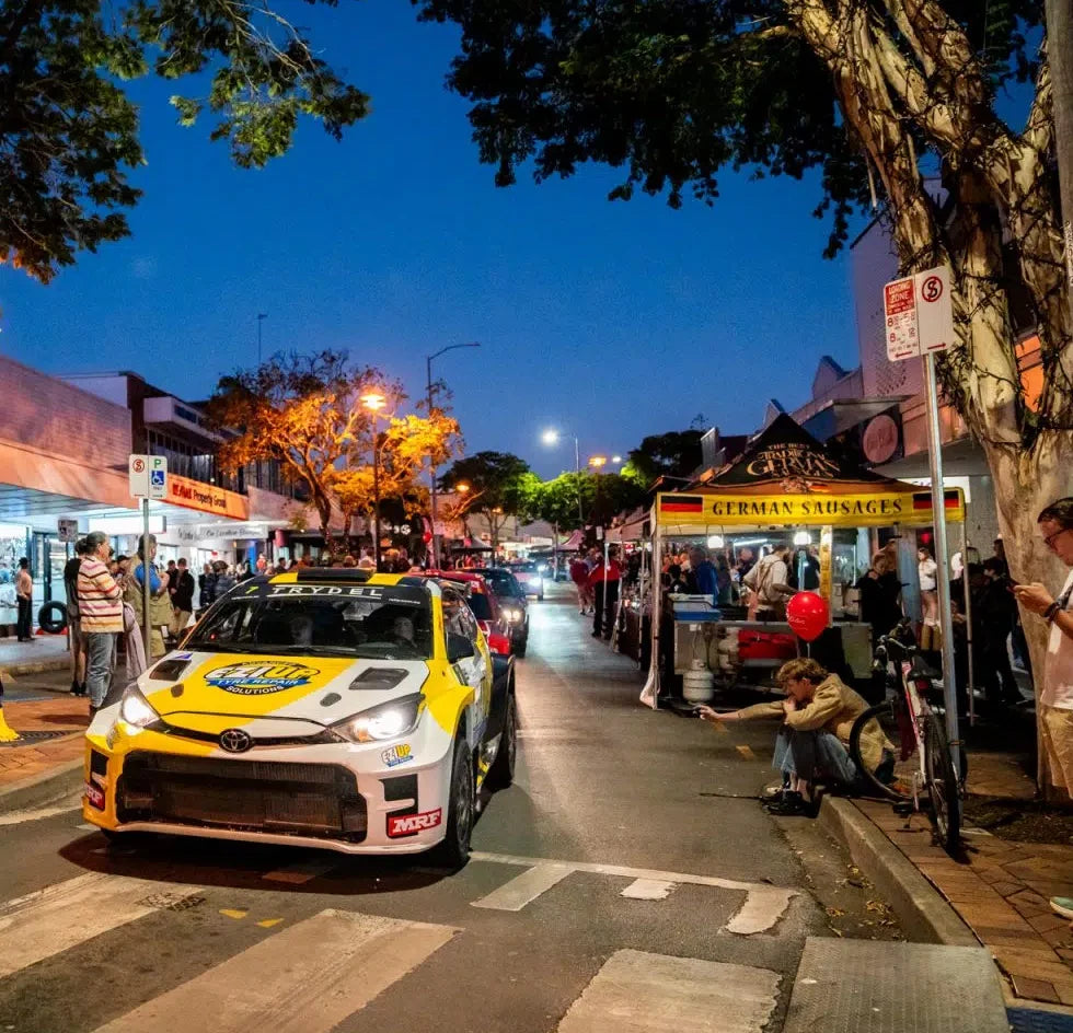 Rally car passing our German Sausages tent in Gympie